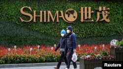 资料照:行人走过上海街头世茂集团的标识。(2022年1月13日)