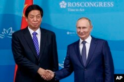 资料照:中共人大委员长栗战书在符拉迪沃斯托克会见俄罗斯总统普京。(2022年9月7日)