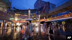 资料照片:2024年7月2日,在中国北京三里屯太古里购物中心购物的人们。(美联社照片)