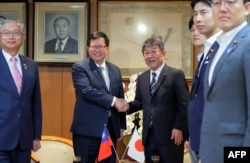 日本自民党干事长茂木敏充在东京会晤到访的台湾行政院副院长郑文灿(左)。(2023年6月28日)