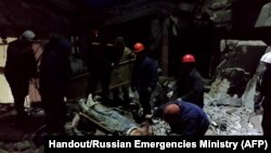This grab from footage released by the Russian Emergencies Ministry on Feb. 3, 2024, shows rescuers removing victims and searching for survivors inside a bakehouse hit by shelling in Lysychansk. AFP PHOTO / Russian Emergencies Ministry