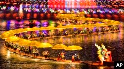 中共官媒新华社发布照片显示,游客们在湖北省宣恩县乘坐竹筏参加迎新春灯会游湖活动。(2024年2月11日)