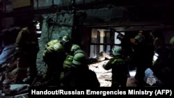 This screen grab from footage released by the Russian Emergencies Ministry on Feb. 3, 2024, shows rescuers removing victims and searching for survivors inside a bakehouse hit by shelling in Russia-occupied Lysychansk, Ukraine. AFP PHOTO / Russian Emergencies Ministry