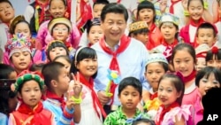 北京一个展览会的照片显示中国领导人习近平和中国孩子的合影。(2017年9月28日)