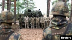 FILE - Soldiers stand in line at a training site as they undergo maintenance training on Leopard 1 A5 tanks, at the German army Bundeswehr base, part of the EU Military Assistance Mission in support of Ukraine in Klietz, Germany, Feb. 23, 2024.