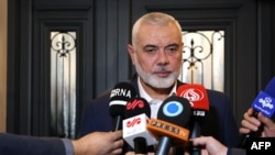 伊朗外交部12月20日发布照片显示,以卡塔尔为基地的哈马斯最高领导人伊斯梅尔·哈尼亚(Ismail Haniyeh)在多哈举行的一个记者会上讲话。