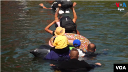 在墨西哥边境城市马塔莫罗斯,泅渡界河游向美国的移民。