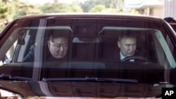 FILE - Russian President Vladimir Putin, right, and North Korea's leader Kim Jong Un drive a Russian Aurus limousine during their meeting in Pyongyang, North Korea, June 19, 2024. (Kremlin photo via AP)