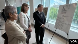 台湾驻美代表俞大㵢(右1)与乔治华盛顿大学席格尔亚洲研究中心主任珍妮特·斯蒂尔(中)观看纪念《台湾关系法》45周年照片展。(2024年5月7日,美国之音锺辰芳拍摄)