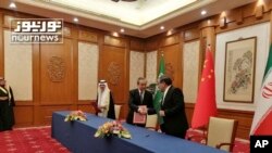 2023年3月10日,伊朗最高国家安全委员会秘书阿里·沙姆哈尼(右)在北京的会谈结束后同中共外事主管王毅握手。照片最左边是沙特国务大臣、内阁成员和国家安全顾问穆萨伊德·本·穆罕默德·艾班。