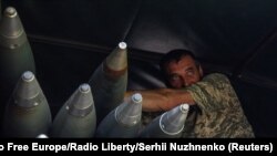 2023年5月19日,在乌克兰前线城镇巴赫穆特附近,一名乌克兰军人站在一辆装载BM-21 Grad多管发射系统的卡车上。