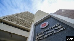 Central Bank of Sri Lanka logo is pictured on the building facade of its head office in Colombo. (Photo by Ishara S. KODIKARA / AFP)