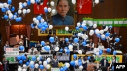 在台湾立法院审议国会改革法案投票时,台湾执政党民进党议员在立法院院长韩国瑜 (中) 的注视下放气球。(2024年5月24日)