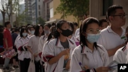 FILE - Students line up for their first day of China's national college entrance examinations, known as the gaokao, in Beijing, June 7, 2023.
