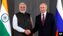 FILE - Russian President Vladimir Putin, right, and Indian Prime Minister Narendra Modi pose for a photo on the sidelines of the Shanghai Cooperation Organization (SCO) summit in Samarkand, Uzbekistan, Sept. 16, 2022.