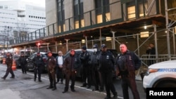 Police officers gather outside Manhattan Criminal Court after former President Donald Trump's indictment by a Manhattan grand jury following a probe into hush money paid to Stormy Daniels, in New York, March 30, 2023.