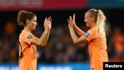 Netherlands' Dominique Janssen celebrates with Stefanie van der Gragt after the match against Portugal, July 23, 2023.