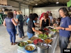 中午大家分享各自带来的餐点, 原本的工作聚会,一下子变成了丰盛的餐会。(美国之音/赖素芬)