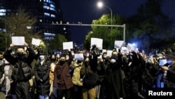 资料照片:北京的年轻人手举白纸上街示威,抗议新冠清零封控政策。(2022年11月27日)