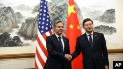 U.S. Secretary of State Antony Blinken, left, shakes hands with Chinese Foreign Minister Qin Gang, right, at the Diaoyutai State Guesthouse in Beijing, China, June 18, 2023.