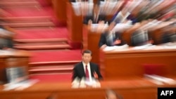 资料照:中国领导人习近平在北京人大会堂出席全国人大会议开幕式。(2024年3月4日)