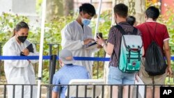 纽约市卫生与心理健康局的医疗保健工作者在该市一处疫苗接种站帮助人们登记接种猴痘疫苗。(2022年7月26日)