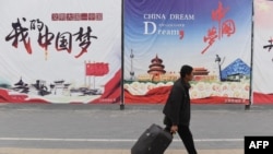 资料照:一名男子走过北京街头张贴的中国梦宣传画。(2017年4月4日)
