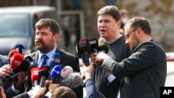 FILE - Mykhailo Podolyak, adviser to Ukrainian President Volodymyr Zelenskyy and member of the Ukrainian delegation, center right, speaks to the media after talks between Russian and Ukrainian delegations, in Istanbul, March 29, 2022.