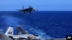 中共党媒新华社2021年12月31日发布照片显示,在一次演习中解放军歼-15战机在辽宁号航母上降落。