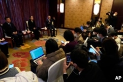 中国疾控中心流行病学首席专家吴尊友(右)在北京举行的记者会上讲话。(2022年12月29日)