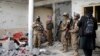 资料照片：在阿富汗喀布尔以东的贾拉拉巴德郊区，塔利班武装突袭“伊斯兰国”武装分子的一个疑似藏身点后检查了一所房子。当天，塔利班和“伊斯兰国”武装分子之间爆发了长达8小时的枪战。(2021年11月30日）