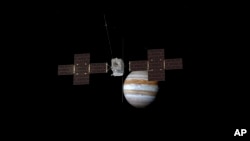 This image provided by the European Space Agency depicts the Jupiter Icy Moons Explorer, Juice, spacecraft orbiting the gas giant. (ESA/ATG Medialab via AP)