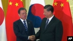 中国国家主席习近平在北京会见时任韩国总统文在寅。(美联社2019年12月23日)