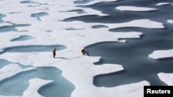 FILE - The crew of the U.S. Coast Guard Cutter Healy, in the midst of their ICESCAPE mission to study sea ice, retrieves supplies in the Arctic Ocean, July 12, 2011.