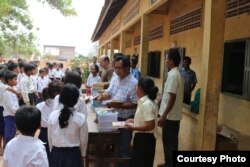 Im Chaem with students during donation of books, pen and study tools with a US Christian missionary team led by Pastor Christopher LaPel in November 2017 near her home in O'Angre village, Anlong Veng District, Oddar Meanchey province. Photo by Pastor Touc