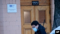 2022年2月4日,一名记者从德国公共广播电台“德国之声”在莫斯科的办公室招牌前走过。(美联社)