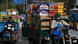 资料照:装满货物的车辆行驶在北京街头。 (2022年9月21日)