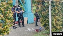 Police investigators inspect the crime scene after a shooting at the Ateneo de Manila University, in Quezon City, Metro Manila, Philippines, July 24, 2022.