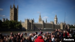 Members of the public line up as they wait to view Queen Elizabeth II's lying in state ahead of her funeral on Monday, in London, Sept. 17, 2022.