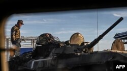 A Ukrainian fighter stands on the top of a tank in Kharkiv, Sept. 9, 2022, amid the Russian invasion of Ukraine.