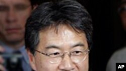 Cambodian rescuers work at the site of a factory collapse in Kai Ruong village, south of Phnom Penh, May 16, 2013.