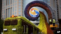 工人们在北京修建火车形状的花草,宣传即将召开的“一带一路”高峰论坛(2019年4月23日)