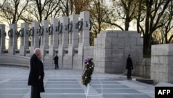 在国家珍珠港纪念日这天,美国总统乔·拜登和第一夫人吉尔·拜登在华盛顿特区第二次世界大战纪念碑前敬献花圈。(2021年12月7日)