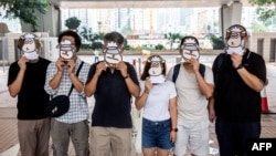 资料照:支持民主的香港跨工会联盟的支持者2021年7月23日在西九龙法院外戴上羊面具抗议。香港言语治疗师总工会成员现在因“羊村”系列儿童绘本被警方国安处人员拘捕,指控他们涉嫌“串谋刊印、发布、分发、展示或复制煽动刊物”罪。