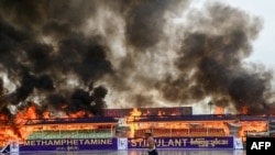 Smoke rises from a burning pile of seized illegal drugs during a destruction ceremony to mark the United Nations' "International Day against Drug Abuse and Illicit Trafficking" in Yangon, Myanmar, June 26, 2022.