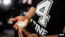 2021年6月1日,一名香港居民身穿纪念六四T恤,手持去年八九六四烛光悼念晚会用过的蜡烛底座,以此纪念天安门事件32周年。