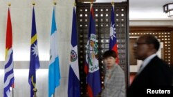 An emergency paramedic leans against a wall outside the Matei Bals hospital compound in Bucharest, Romania, where an early-morning fire killed four people, authorities said.