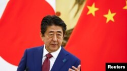 资料照:时任日本首相的安倍晋三在北京人大会堂出席记者会 (2018年10月26日 ,路透社)