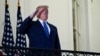 FILE PHOTO: U.S. President Donald Trump poses without face mask as he returns to the White House after being hospitalized at Walter Reed Medical Center for coronavirus disease (COVID-19), in Washington