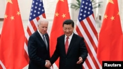 A Jammu and Kashmir state policeman performs a motorcycle stunt during the Republic Day parade in Jammu, India.